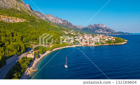 Mediterranean hillside settlement overlooking turquoise coves on Makarska Riviera Croatia captured from above during golden hour Mediterranean hillside settlement overlooking turquoise coves on Makarska Riviera Croatia captured from above during golden hour 132169604