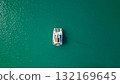 Top down drone view of white sailing catamaran anchored on turquoise lagoon minimal composition calm summer water 132169645