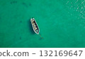 Lonely fishing boat floating above clear teal water overhead composition minimal travel background aesthetic 132169647