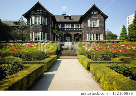 Red rose flower and Western-style building in old Furukawa garden Red rose flower and Western-style building in old Furukawa garden 132169889
