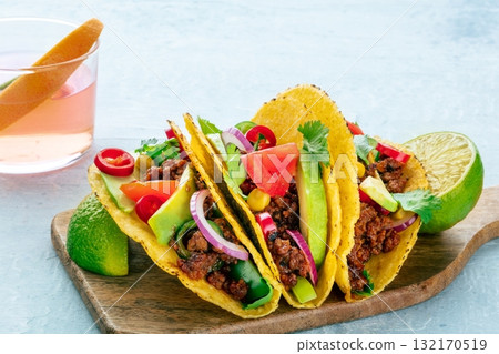 Ground beef tacos and a Paloma cocktail, Mexican food and drink, a close-up Ground beef tacos and a Paloma cocktail, Mexican food and drink, a close-up 132170519