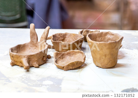 Hand shaping clay pottery in workshop Hand shaping clay pottery in workshop 132171052