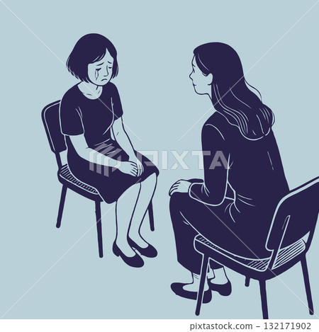 Woman comforting a crying girl during emotional conversation on chairs indoors. Concept of mental health support 132171902