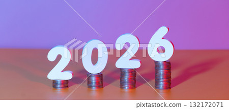 2026 New year saving money and financial planning concept. White number 2026 on stack of coins. Creative idea for business growth, tax payment, investment and banking. 132172071