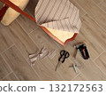 Restore old vintage chair in home. Fabric replacement. Antique furniture and modern striped linen and cotton fabric. Hobbies, crafts, and retro-minimalist style. 132172563