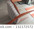 Restore old vintage chair in home. Fabric replacement. Antique furniture and modern striped linen and cotton fabric. Hobbies, crafts, and retro-minimalist style. 132172572