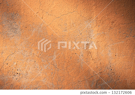 Orange-brown concrete wall texture. Rough stone texture. Stone background. Cracked paint and poster. Orange-brown concrete wall texture. Rough stone texture. Stone background. Cracked paint and poster. 132172606