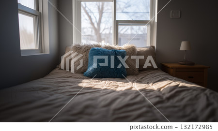 Cozy bedroom with fluffy blue pillow and soft winter window light Cozy bedroom with fluffy blue pillow and soft winter window light 132172985