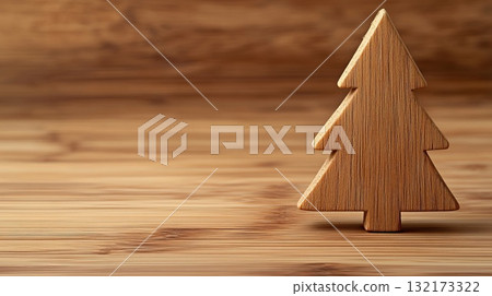 A wooden Christmas tree stands on a rustic wooden table, with a snowy backdrop. Christmas decor and craftwork, eco friendly, sustainable, zero waste concept. Place for text. 132173322