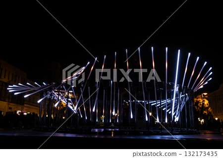 The fascinating night scene captures a modern light installation that dominates the space with a futuristic aesthetic and consists The fascinating night scene captures a modern light installation that dominates the space with a futuristic aesthetic and consists 132173435