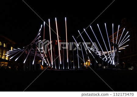 The fascinating night scene captures a modern light installation that dominates the space with a futuristic aesthetic and consists The fascinating night scene captures a modern light installation that dominates the space with a futuristic aesthetic and consists 132173470