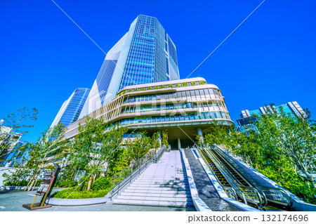 Tokyo cityscape in Japan. View of Takanawa Gateway City in front of Takanawa Gateway Station. Water flows like a waterfall. 132174696