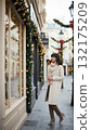 Smiling woman looking at a Christmas shop window 132175209