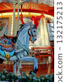 Christmas carousel with horses on the square in the city 132175213