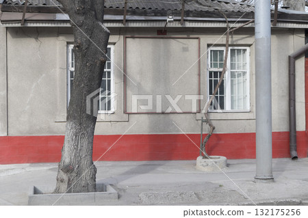 A one-storey building with a red basement. A one-storey building with a red basement. 132175256
