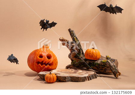 Empty wooden log on table with pumpkin and bats. Halloween or Thanksgiving mock up for products. Empty wooden log on table with pumpkin and bats. Halloween or Thanksgiving mock up for products. 132175609
