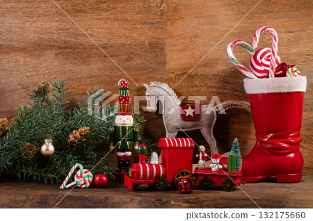 Saint Nicholas Day or Nikolaus, german holiday, December 6. Children toys and shoes with traditional sweets. 132175660