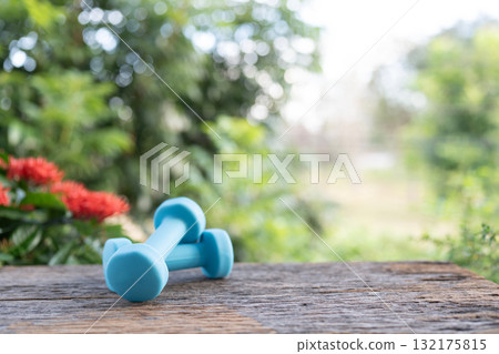 Blue dumbbells on wooden table 132175815