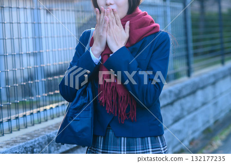 High school girls going to and from school for club activities on a cold day. High school girls going to school while warming their hands in winter clothes. Going to and from school. Trimming. High school girls going to and from school for club activities on a cold day. High school girls going to school while warming their hands in winter clothes. Going to and from school. Trimming. 132177235