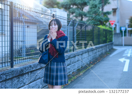 High school girls going to and from school for club activities on a cold day; high school students going to school while warming their hands in winter clothes; going to and from school High school girls going to and from school for club activities on a cold day; high school students going to school while warming their hands in winter clothes; going to and from school 132177237