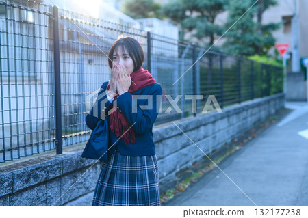 High school girls going to and from school for club activities on a cold day; high school students going to school while warming their hands in winter clothes; going to and from school High school girls going to and from school for club activities on a cold day; high school students going to school while warming their hands in winter clothes; going to and from school 132177238