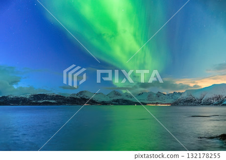 Tromso Norway, aurora borealis northern lights winter landscape at Rorvikneset Sommaroy Tromso Norway, aurora borealis northern lights winter landscape at Rorvikneset Sommaroy 132178255