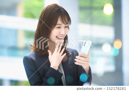 Business woman operating a smartphone Business woman operating a smartphone 132178281
