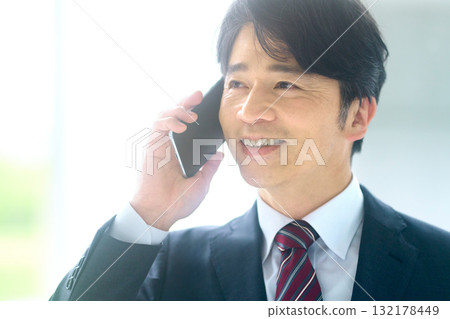 Businessman talking on a smartphone 132178449