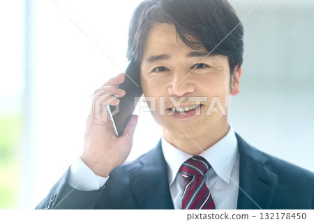 Businessman talking on a smartphone 132178450