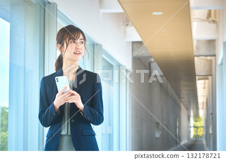 Business woman with a smartphone Business woman with a smartphone 132178721