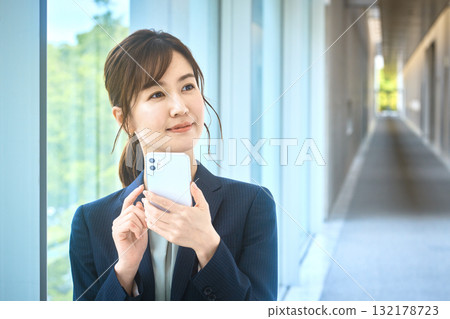 Business woman with a smartphone Business woman with a smartphone 132178723