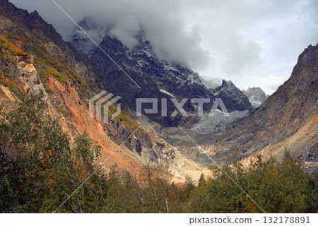 Chalaadi Glacier, ice, glacial flour, moraine, and snow in the Caucasus Mountains. Mestia, Svaneti, Georgia. 132178891