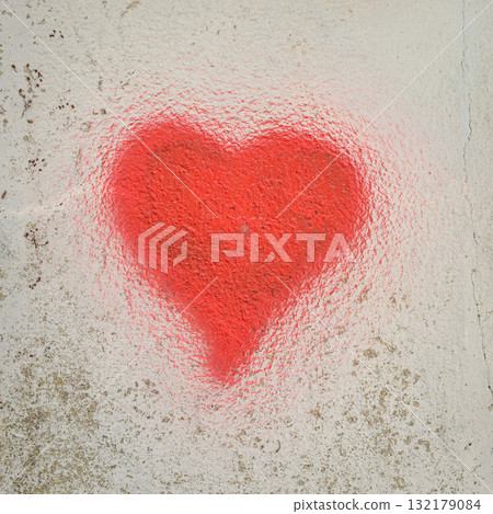 Bright red heart spray-painted on rough textured white wall symbolizes raw emotion and street expression. Concept of graffiti love and urban romantic symbol Bright red heart spray-painted on rough textured white wall symbolizes raw emotion and street expression. Concept of graffiti love and urban romantic symbol 132179084