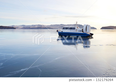 A hovercraft on the ice of the frozen Lake Baikal. Kivus is a transport on ice. A hovercraft on the ice of the frozen Lake Baikal. Kivus is a transport on ice. 132179264