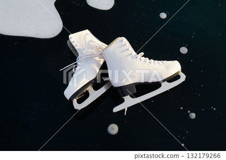 White women's skates for figure skating on the ice of the lake. 132179266
