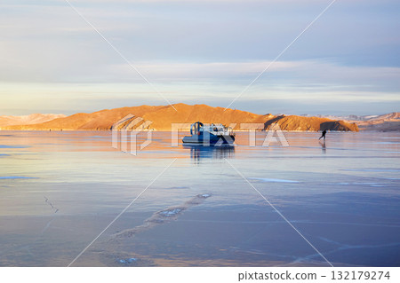 A hovercraft on the transparent ice of the frozen Lake Baikal. A hovercraft on the transparent ice of the frozen Lake Baikal. 132179274