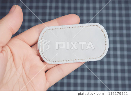 Blank white rectangle embroidered patch lying on hand, ai generated Blank white rectangle embroidered patch lying on hand, ai generated 132179331