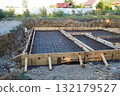 Construction site with wooden formwork and metal rebar. Building a house 132179527