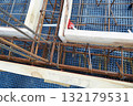 Steel reinforcement is placed in wooden molds and formwork on a construction site 132179531