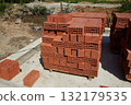 Bricks stacked neatly at a construction site in daylight preparing for building construction activity 132179535