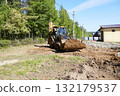 Heavy machinery moves dirt at a construction site with a clear focus on ground leveling and preparation for building 132179537