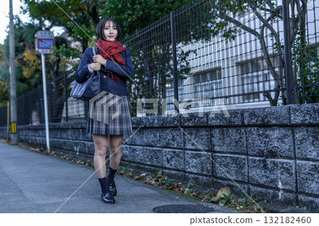 High school girls walking to and from school on a dark road on a cold day. High school girls' skirts, club activities, supplementary classes, going to and from school, negative image High school girls walking to and from school on a dark road on a cold day. High school girls' skirts, club activities, supplementary classes, going to and from school, negative image 132182460