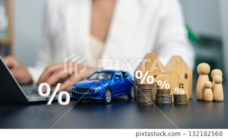 Interest Rate and Investment Concept with House, Car, Coins, and Family Model 132182568