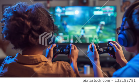 happy couple playing video game with controller on play station at home, friends play computer games on console and have fun 132182781