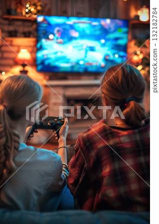happy couple playing video game with controller on play station at home, friends play computer games on console and have fun 132182784