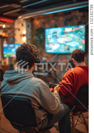 happy couple playing video game with controller on play station at home, friends play computer games on console and have fun 132182786