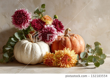 Autumn arrangement with pumpkins and vibrant flowers showcasing seasonal harvest beauty Autumn arrangement with pumpkins and vibrant flowers showcasing seasonal harvest beauty 132183554