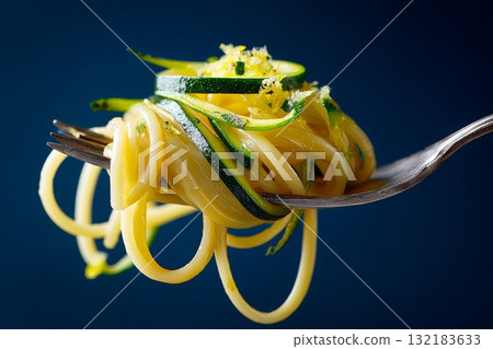 Hyperrealistic close-up of a fork holding spaghetti and zucchini strands with vibrant colors 132183633