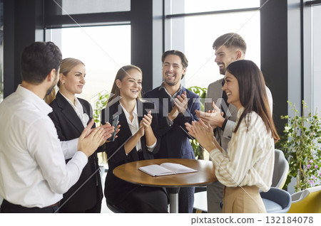 Business people clapping hands on meeting in office, celebrating success or making a deal. 132184078