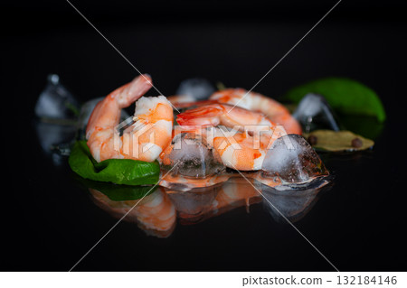 Appetizing shrimp with spices on a black background studio Appetizing shrimp with spices on a black background studio 132184146